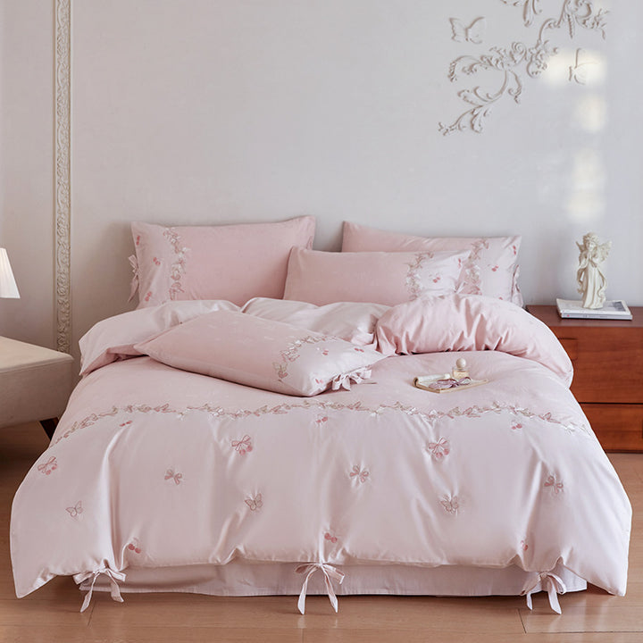 Cotton satin bedding set with butterfly embroidery, decorative bows, and reversible cover