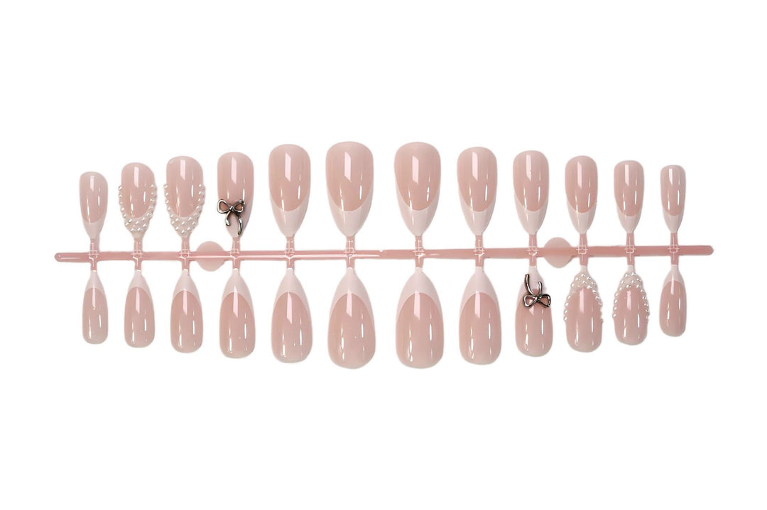 Glamorous artificial nail set with elegant bows and glitter accents Kalsten