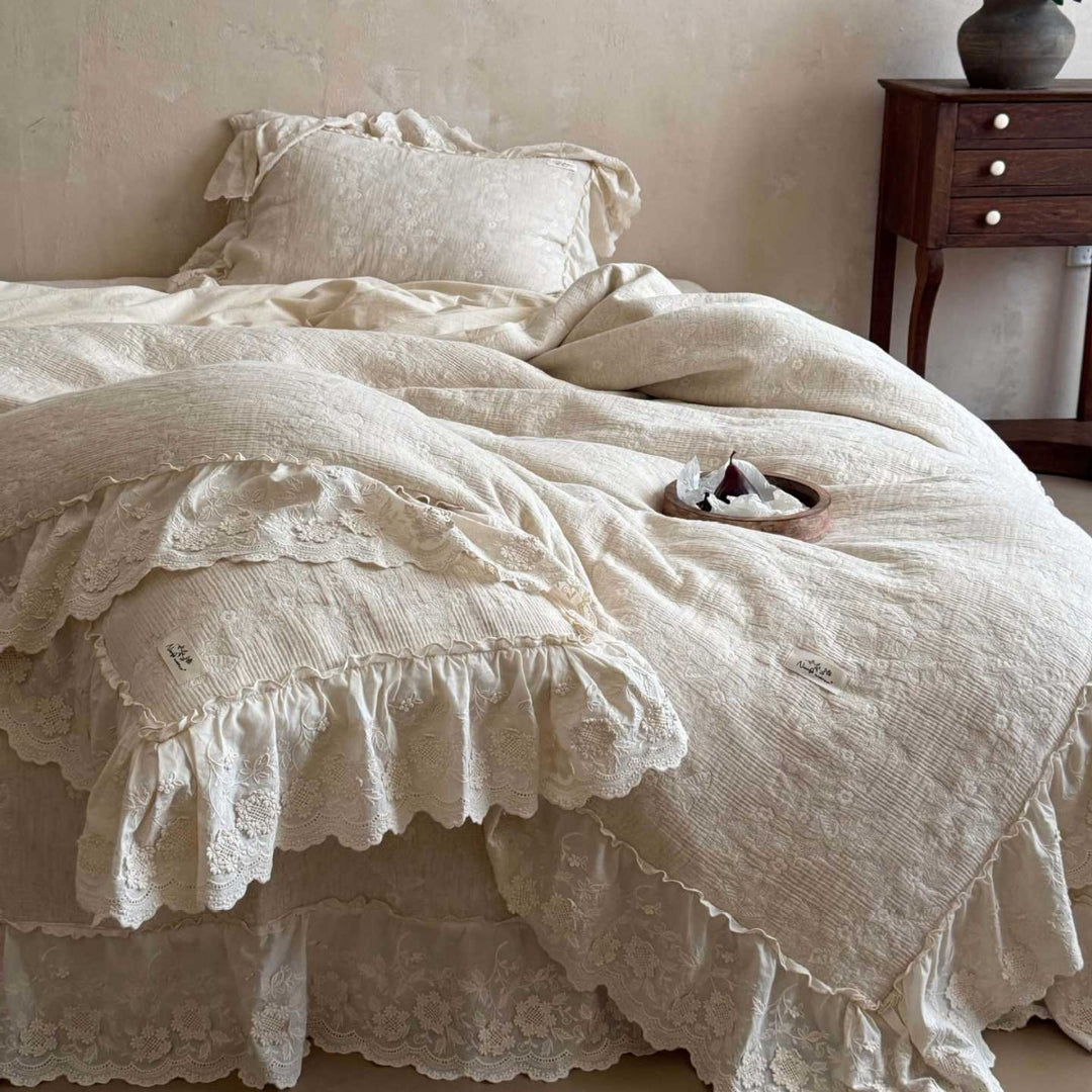 Vintage-inspired ruffled bedding set made of cotton muslin with fine floral embroidery
