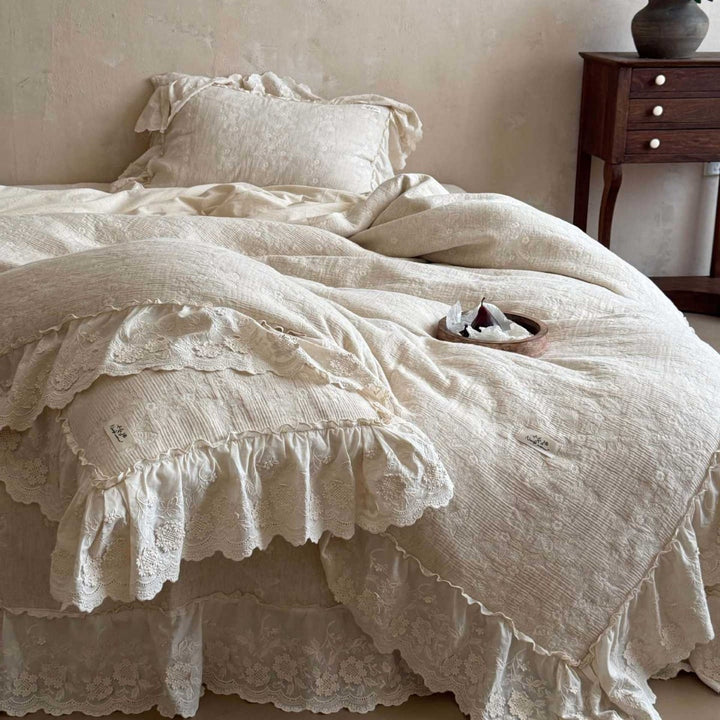 Vintage-inspired ruffled bedding set made of cotton muslin with fine floral embroidery