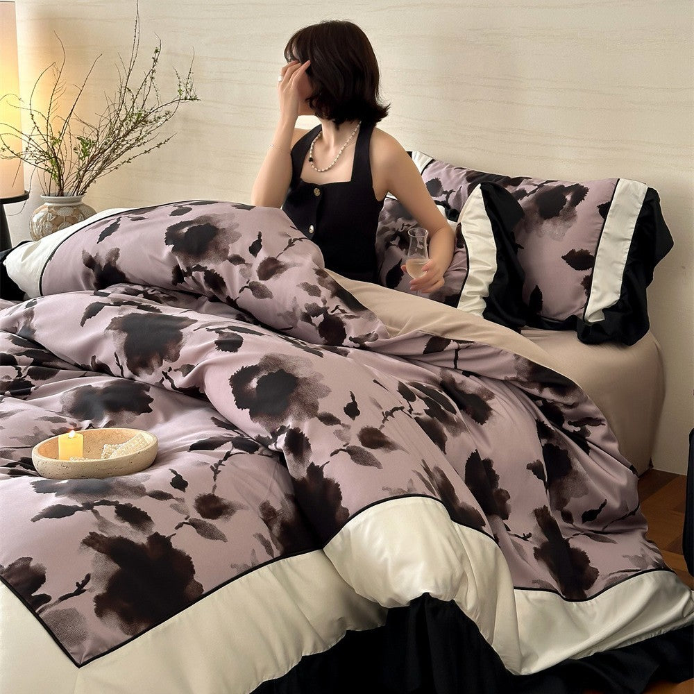 Satin bedding set with watercolored floral print, contrasting piping and flowing ruffles
