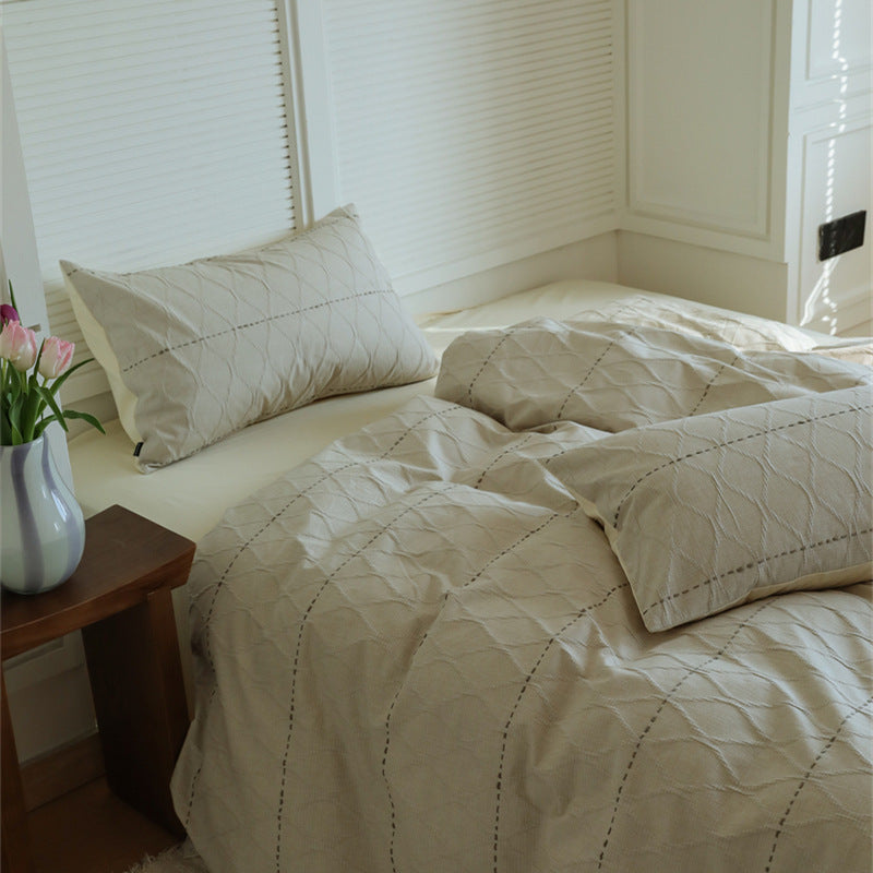 Reversible quilted bedding set made of cotton blend with textured leaf quilting and satin finish back