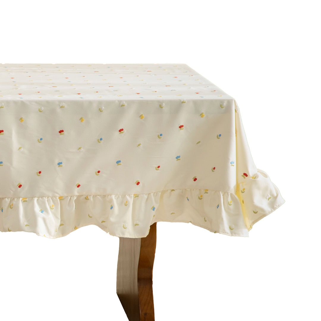 Embroidered tablecloth with ruffle and delicate floral relief