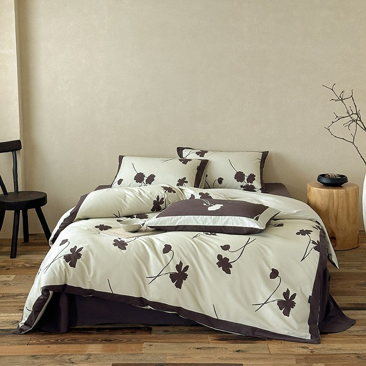 Reversible cotton satin bedding set with floral silhouette print and contrasting piped edge