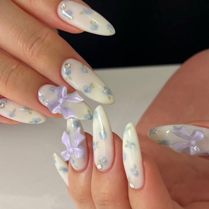 Artful Nail Art with Flower Design and Blue French Tip Kalsten