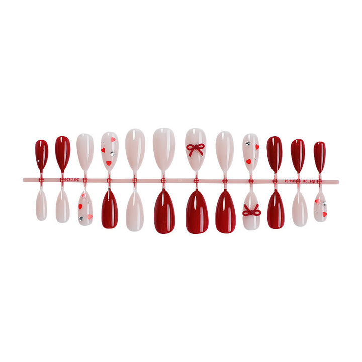 Nail set with elegant red details and hearts Kalsten