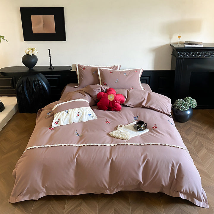 Duvet cover set made of premium cotton satin with subtly embroidered wildflower motif and ruffle edge