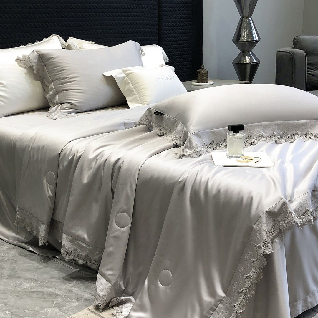Elegant satin bedding set with lace trim and quilted bedspread