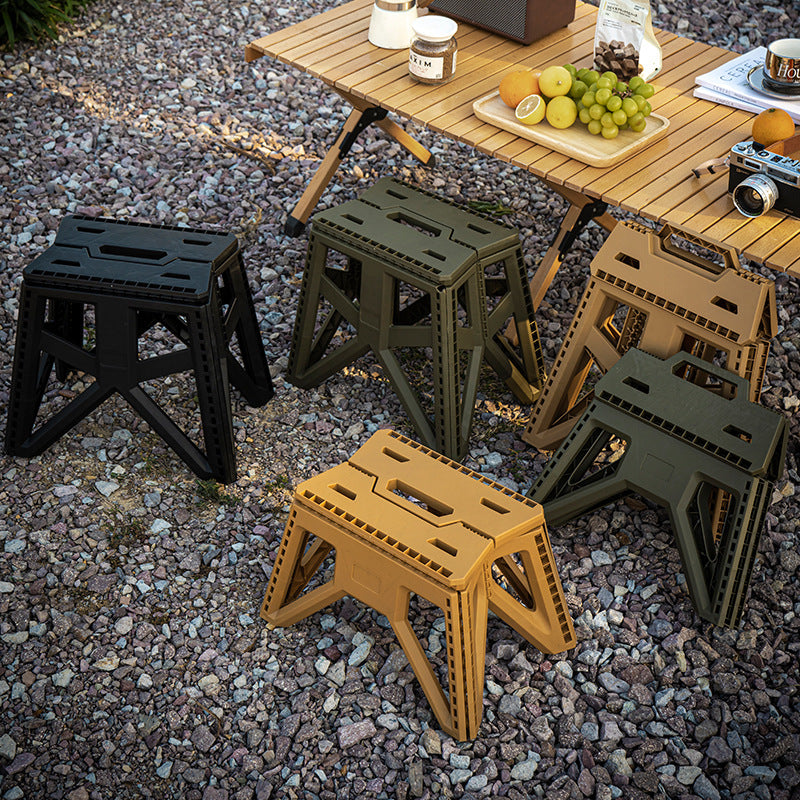 Compact foldable step stool made of shatterproof plastic with carrying handle and non-slip feet