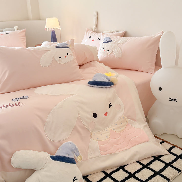 Children's bedding set with three-dimensional ears, plush pillow, and embroidered rabbit appliqués