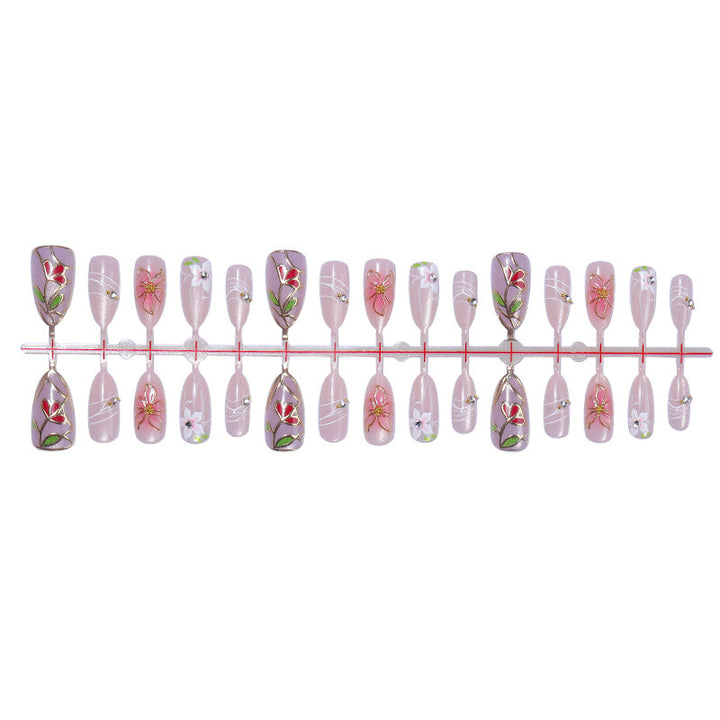 Artificial nail set with luxurious floral designs and glitter accents Kalsten