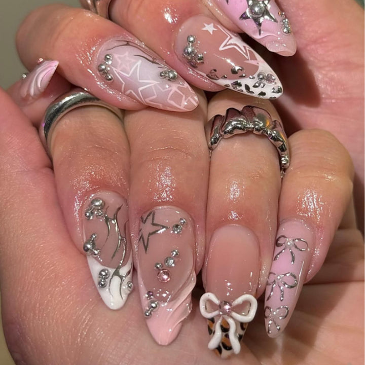 Artful stiletto nails with glitter and bow decorations Kalsten