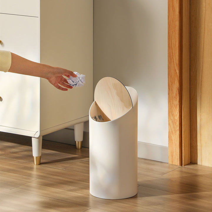 Modern oval waste bin with rotating wooden lid and noise-dampening opening