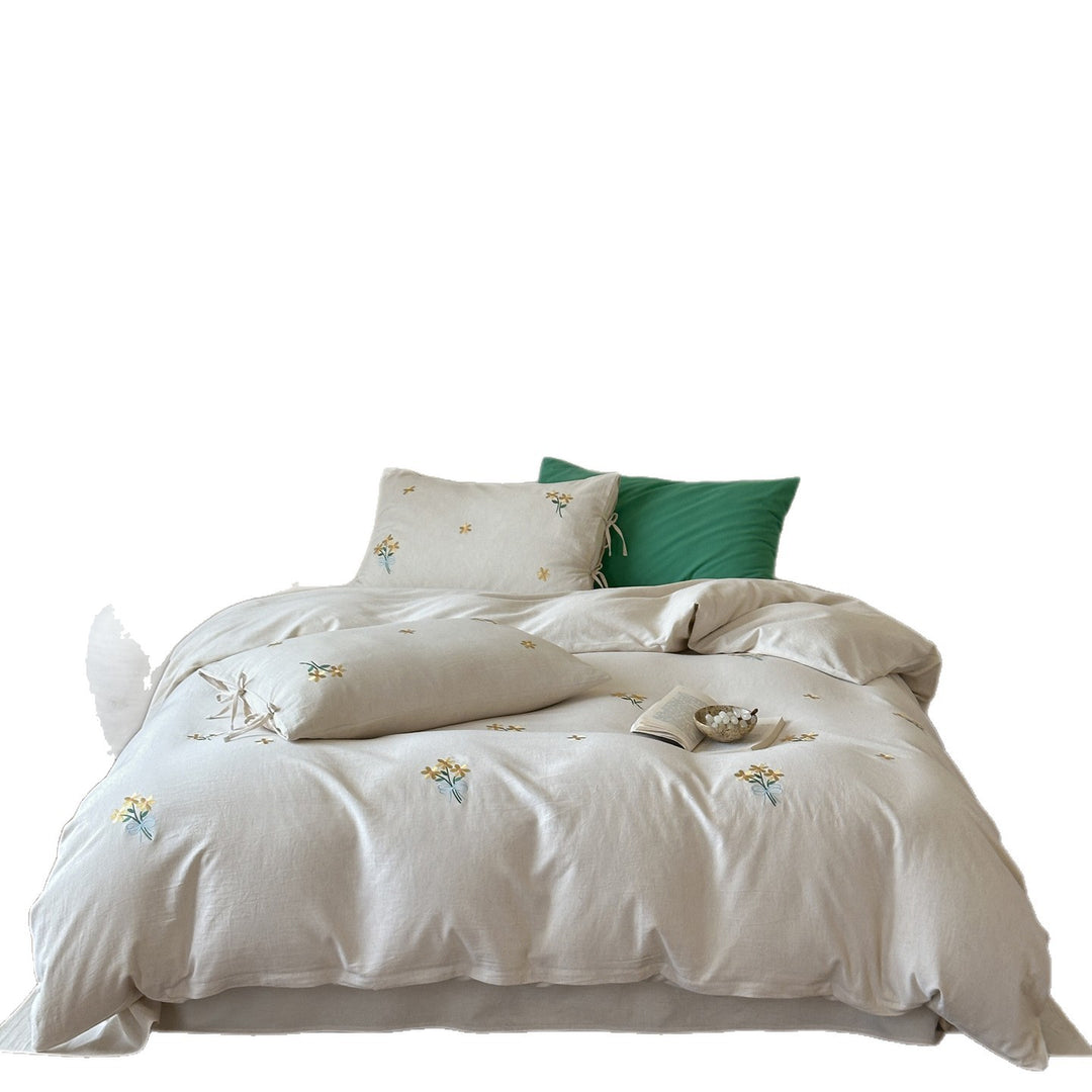 Natural linen duvet cover set with embroidered floral motifs and bow closure