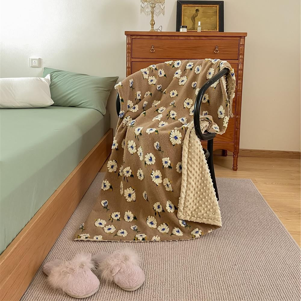 Cuddly blanket with floral bouclé surface and minky reversible fleece