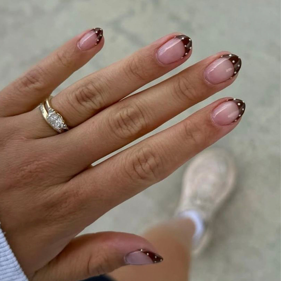Artful nail art with elegant French tips and glitter accents Kalsten