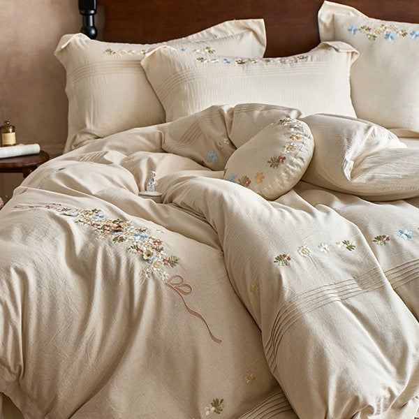 Soft cotton gauze bed set with hand-stitched flowers and decorative ruffle