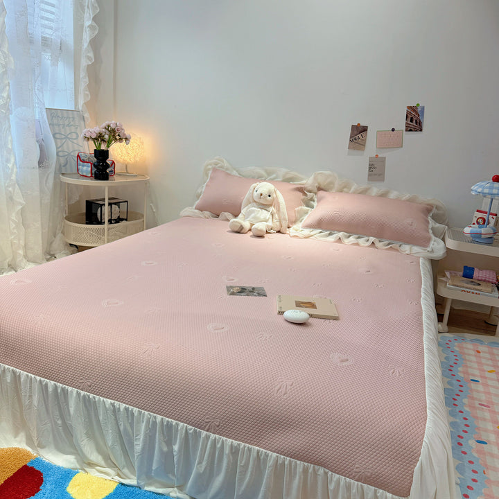 Quilted bedspread with ruffle and delicate floral quilting