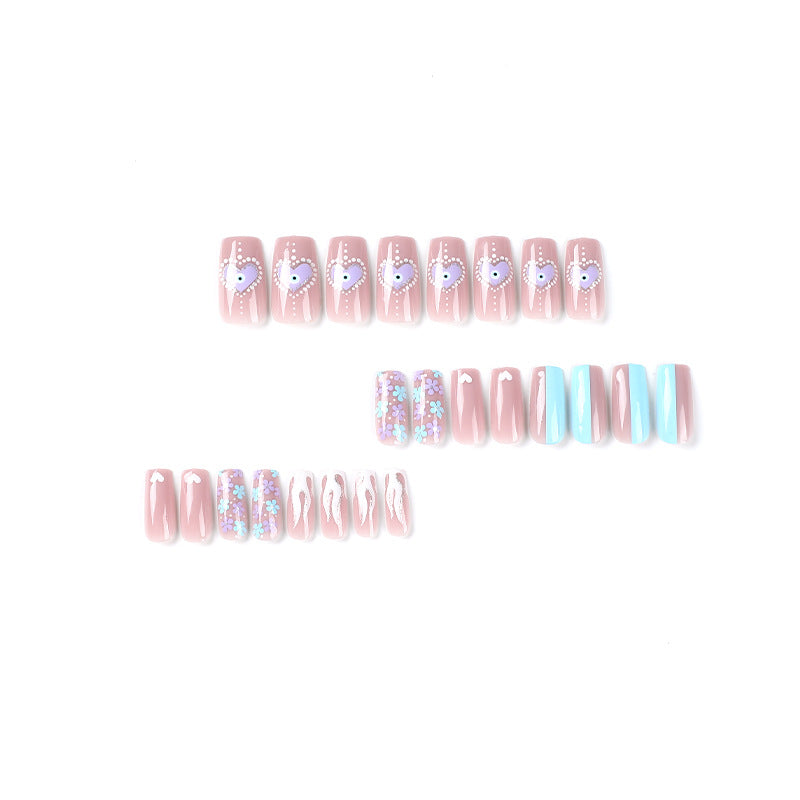 Artful nail art with floral accents and glitter embellishments Kalsten
