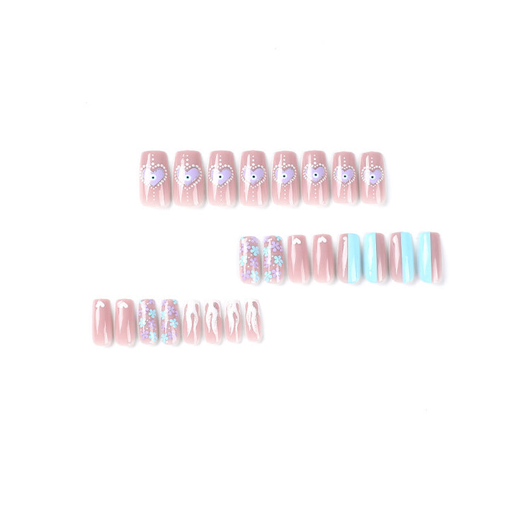 Artful nail art with floral accents and glitter embellishments Kalsten