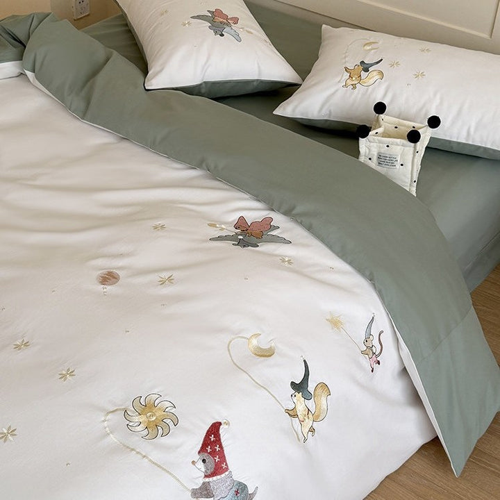 Children's bedding set with embroidered fairy tale forest motifs and reversible option