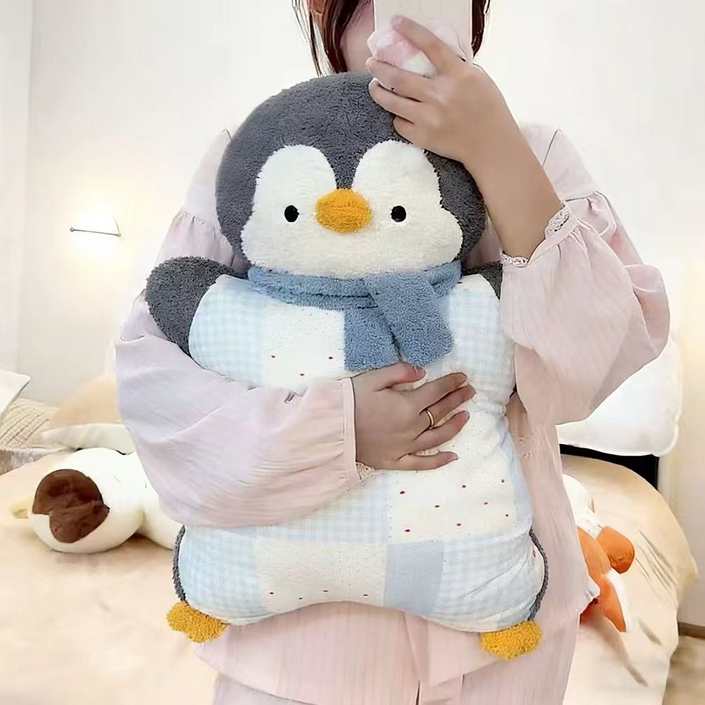 Cozy plush pillow with integrated blanket in penguin look