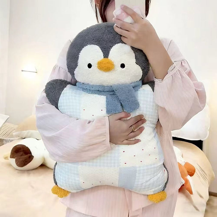 Cozy plush pillow with integrated blanket in penguin look