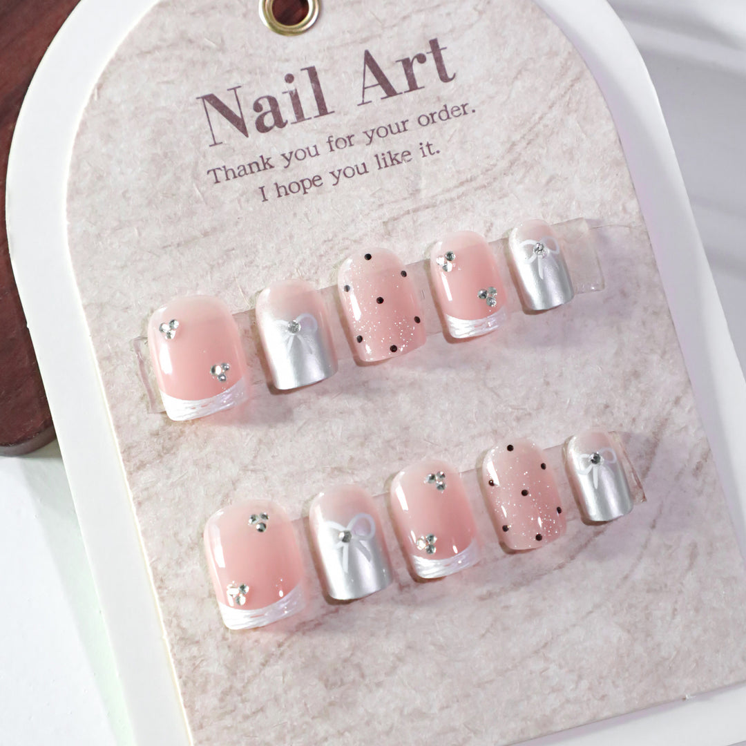 Artistic Nail Art with Bow and Glitter Accents Kalsten