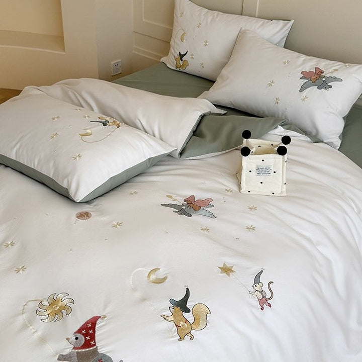 Children's bedding set with embroidered fairy tale forest motifs and reversible option