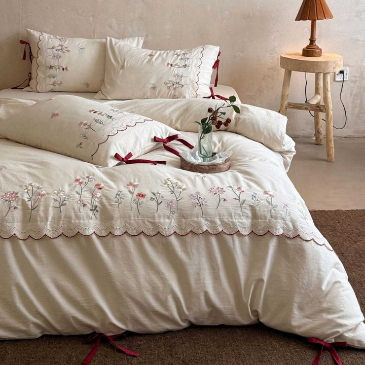 Embroidered bed linen set with lace trim and decorative bows