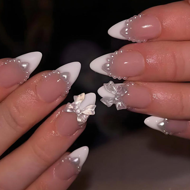 Artificial nail set with elegant tips and playful bow details Kalsten