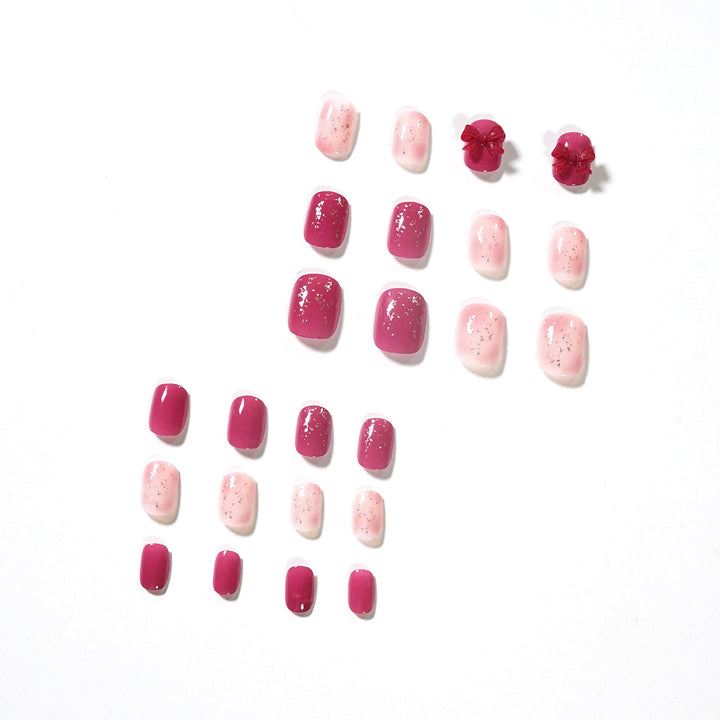 Artificial nail art with glitter embellishments and cute bow motif Kalsten