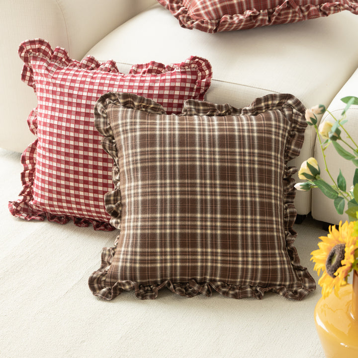 Decorative cushion with gingham pattern and playful ruffled edge