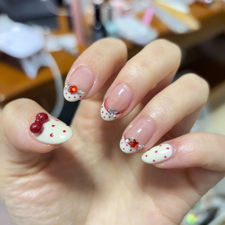 Elegant French Tip Nail Art Extensions with Decorative Accents
