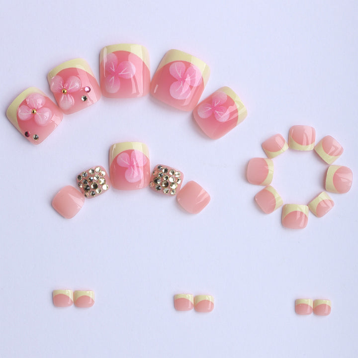 Artificial nail extensions with flower design and glitter accents Kalsten
