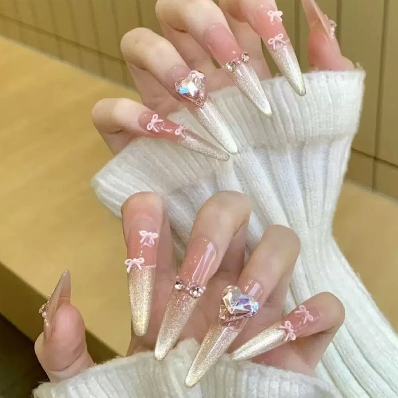 Art nail set with sparkling tips and delicate bow decorations Kalsten