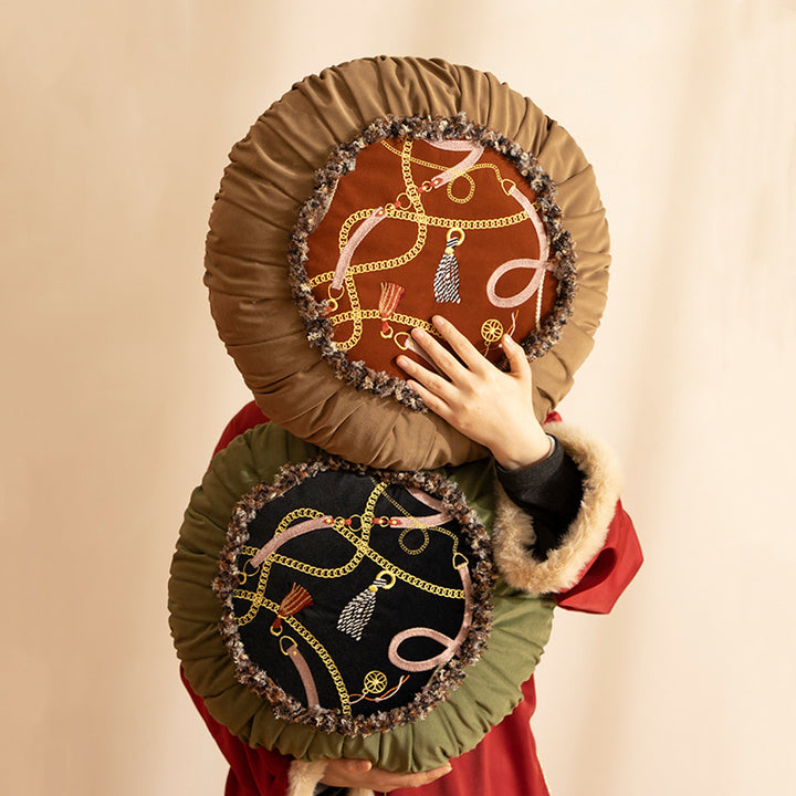 Round decorative cushion with pleated hem and embroidered central panel