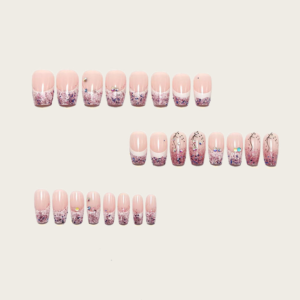 Glamorous artificial nails with glitter and rhinestone embellishments Kalsten