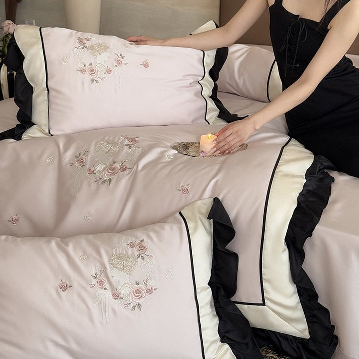 Elegant satin bedding set with floral embroidery relief look, ruffle and contrasting piping seam