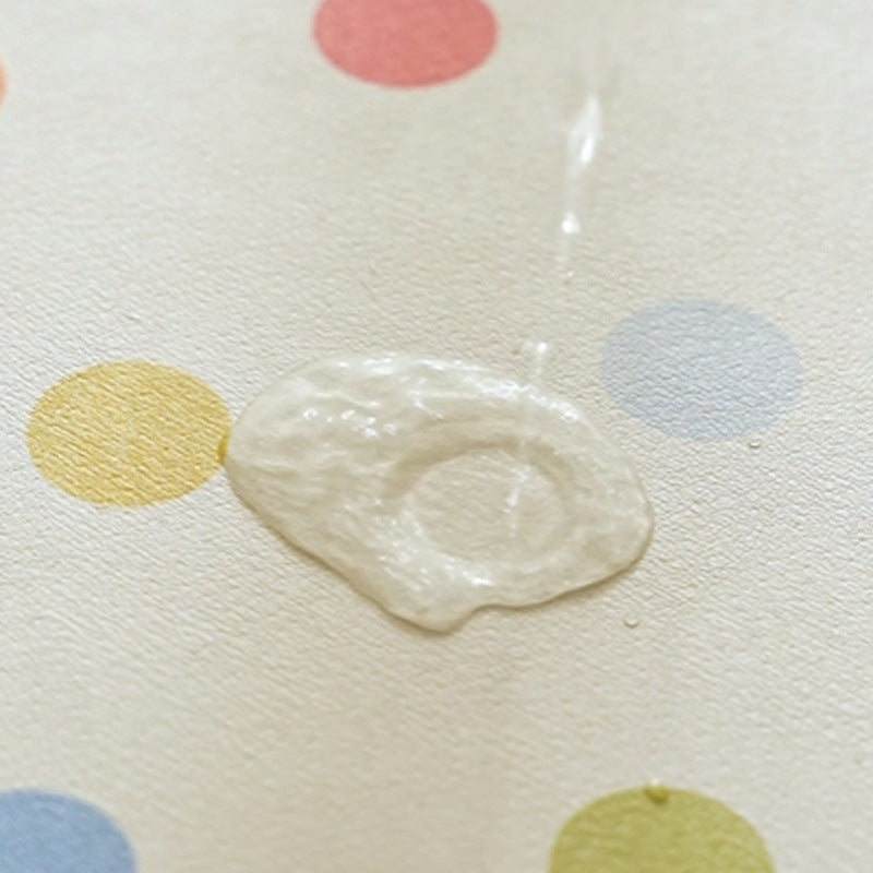 Oval wipeable placemat with pastel-colored polka dots Kalsten
