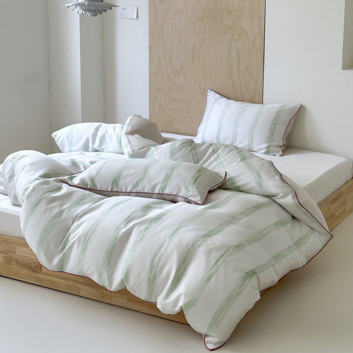 Modern striped bedding set made of cotton satin with hand-drawn stripes and contrasting piping