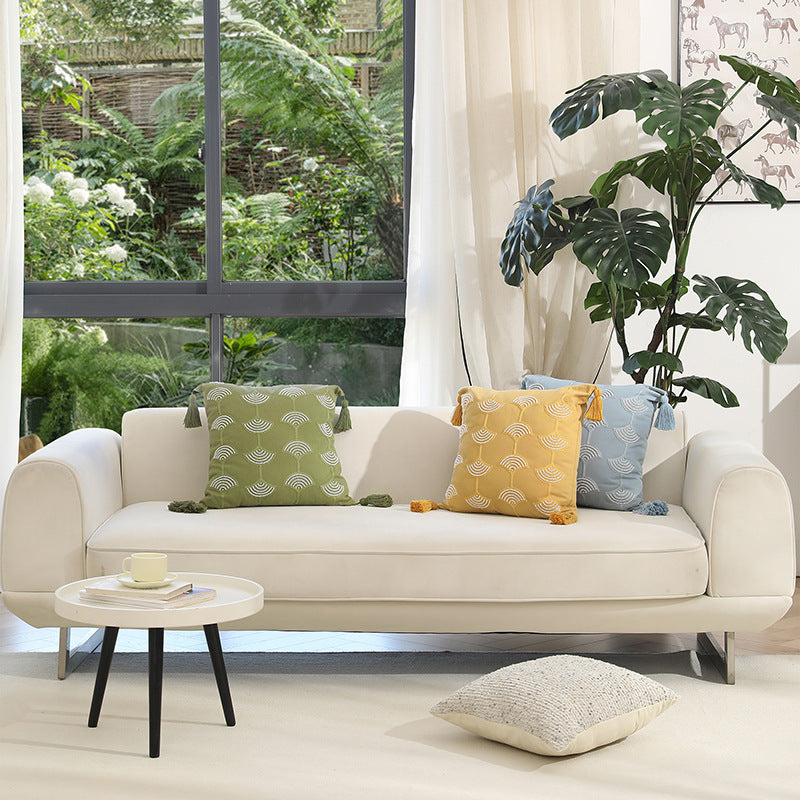 Square decorative pillow with embroidered fan motif and decorative tassels