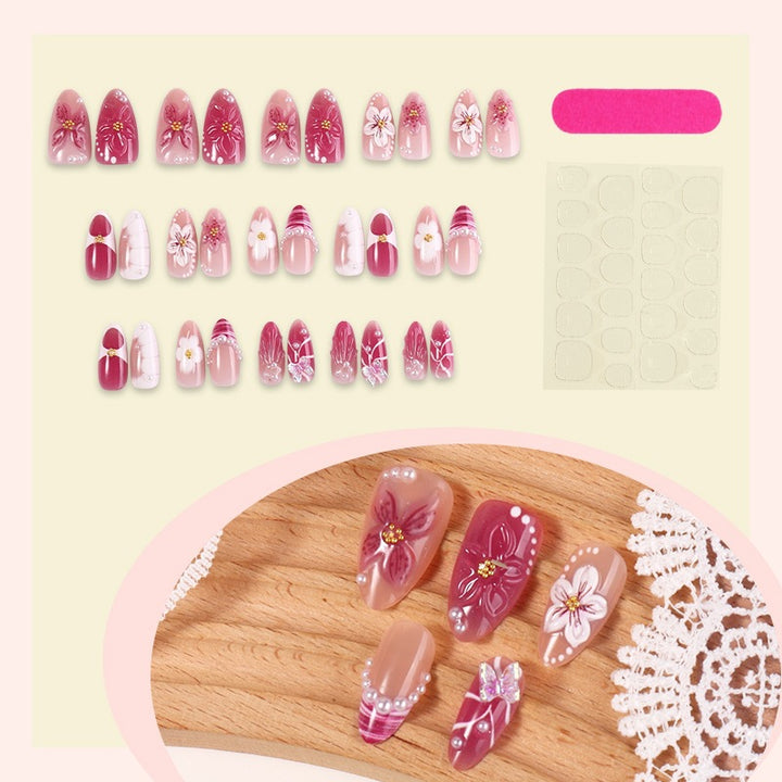 Creative acrylic nail set with floral accents and glitter decorations Kalsten
