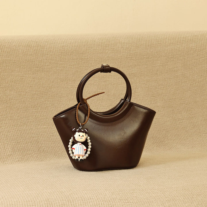 Chic Structured Handbag with Decorative Charm