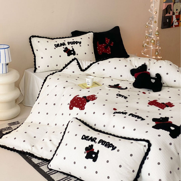 Quilted bedspread and pillow set with embroidered puppy motifs