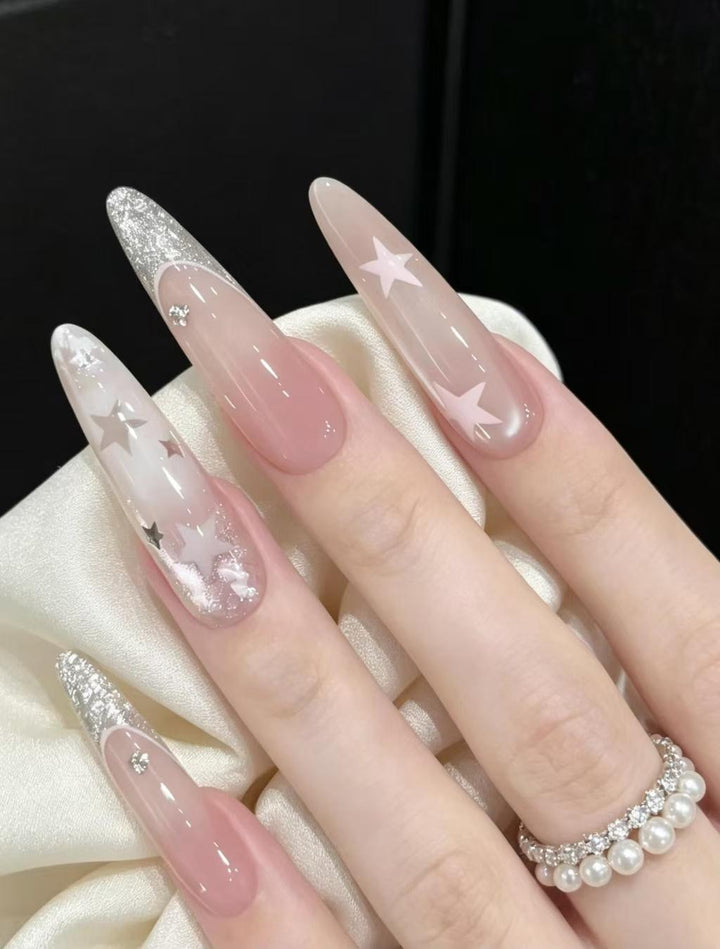Stiletto Nail Enhancements with Glitter and Star Accents