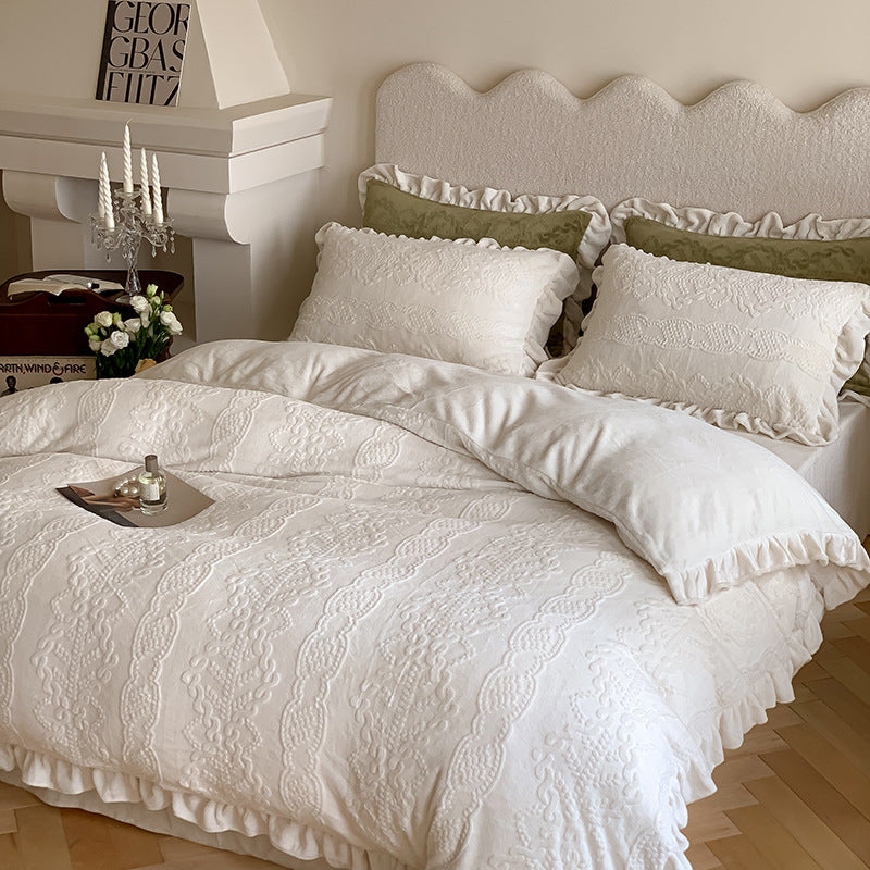 Quilted bedding set with ruffled hem and tone-on-tone embroidery