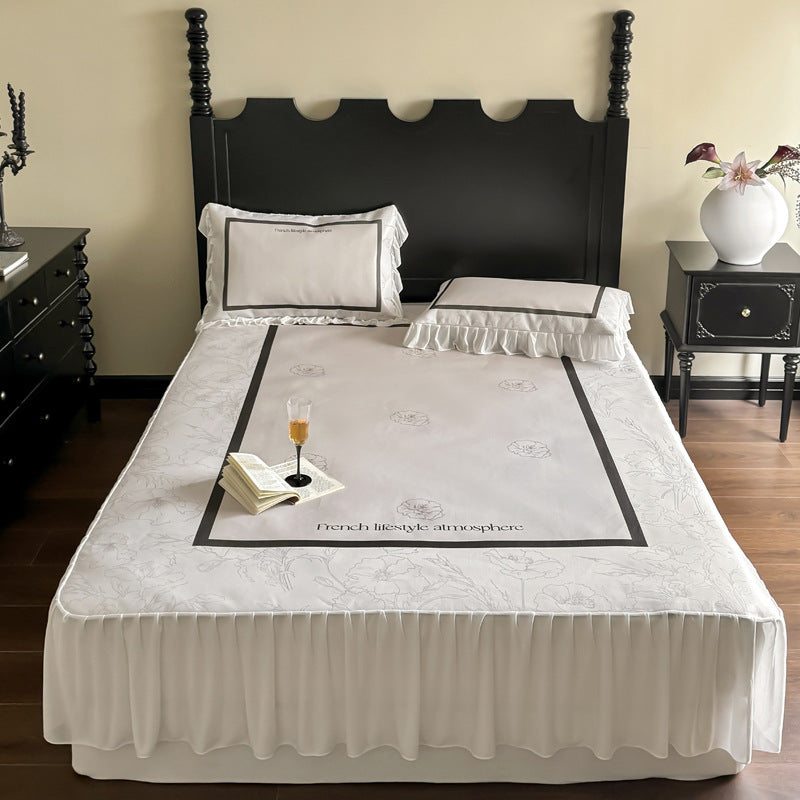 Bedding set with ruffled bed skirt, floral printed center piece and frill pillow