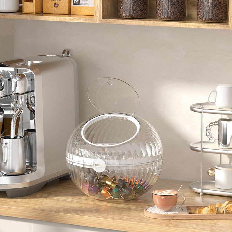 Spherical coffee capsule dispenser made of clear acrylic with flip lid
