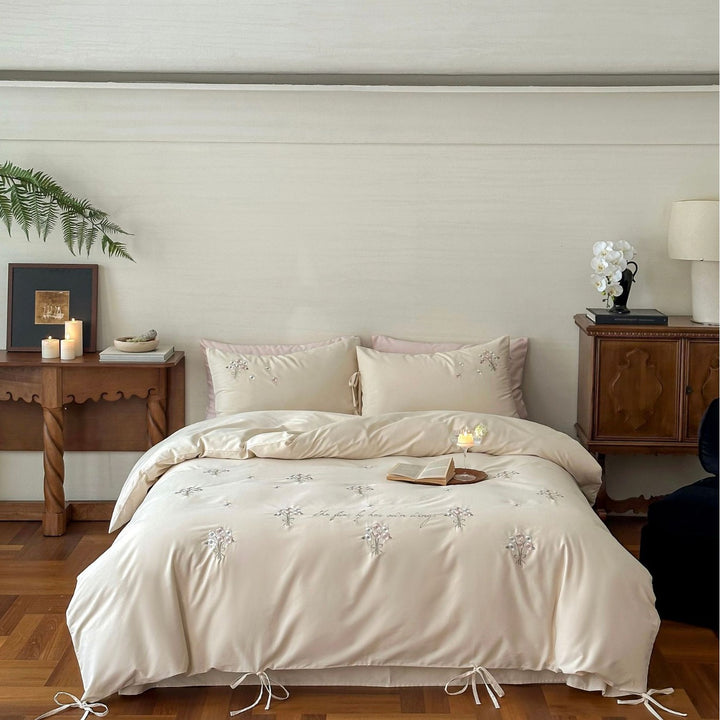 Luxurious satin bedding set with delicate pearl flower embroidery and tie ribbons